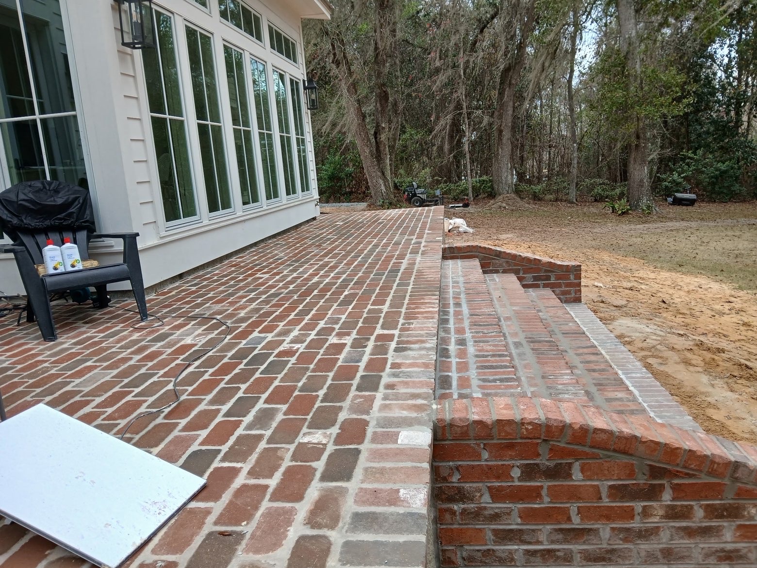 Finished brick patio with raised wall and matching step