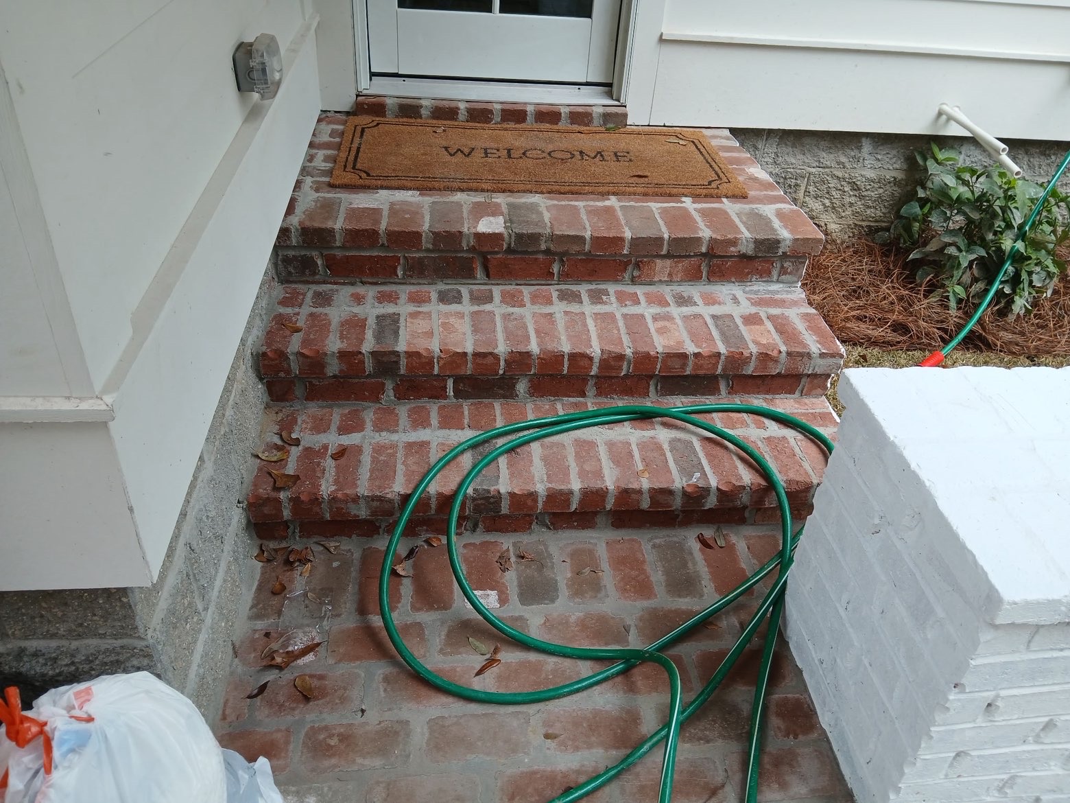 Front entry brick stairs with welcome mat