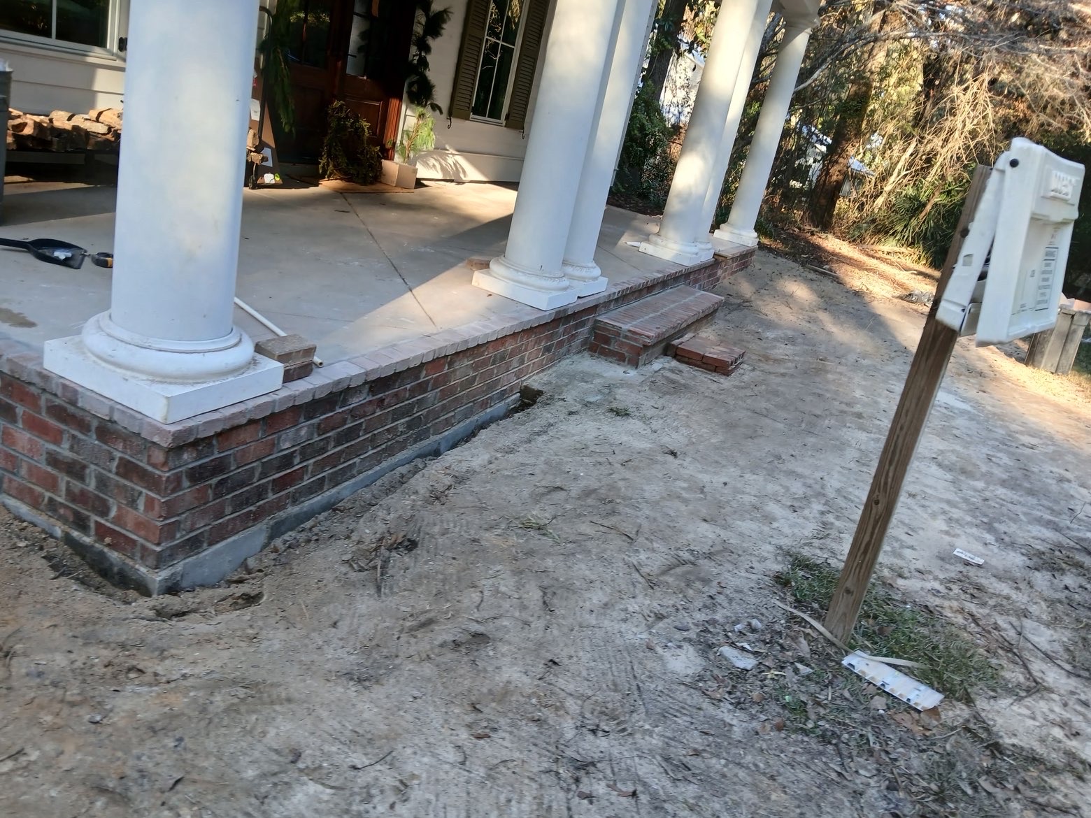 Side angle of brick foundation wrapping the porch