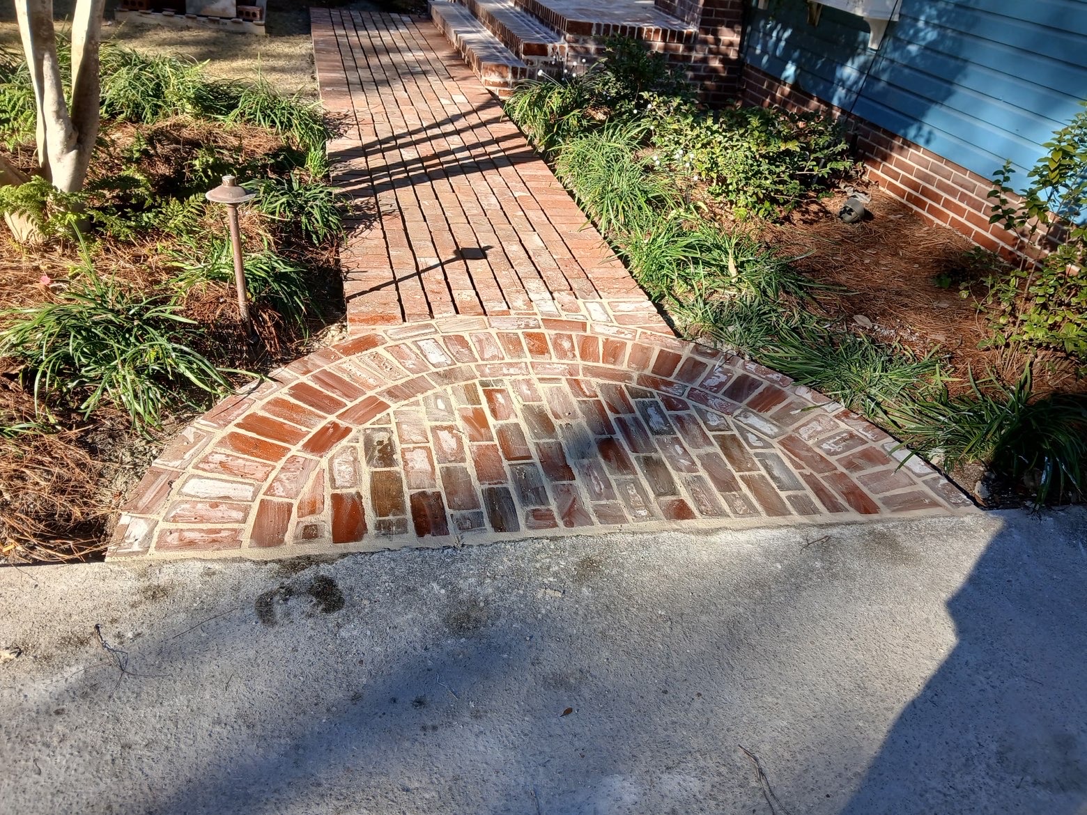 Half-circle brick fan at concrete junction